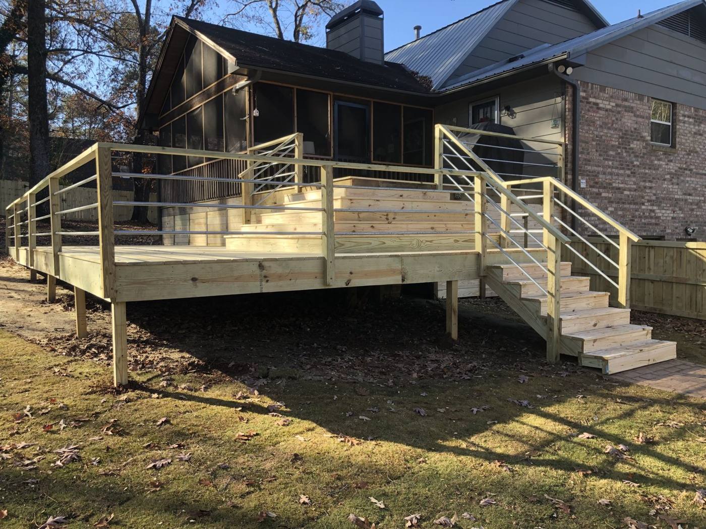 Elevated deck with cable railing built by Redbone Woodworks