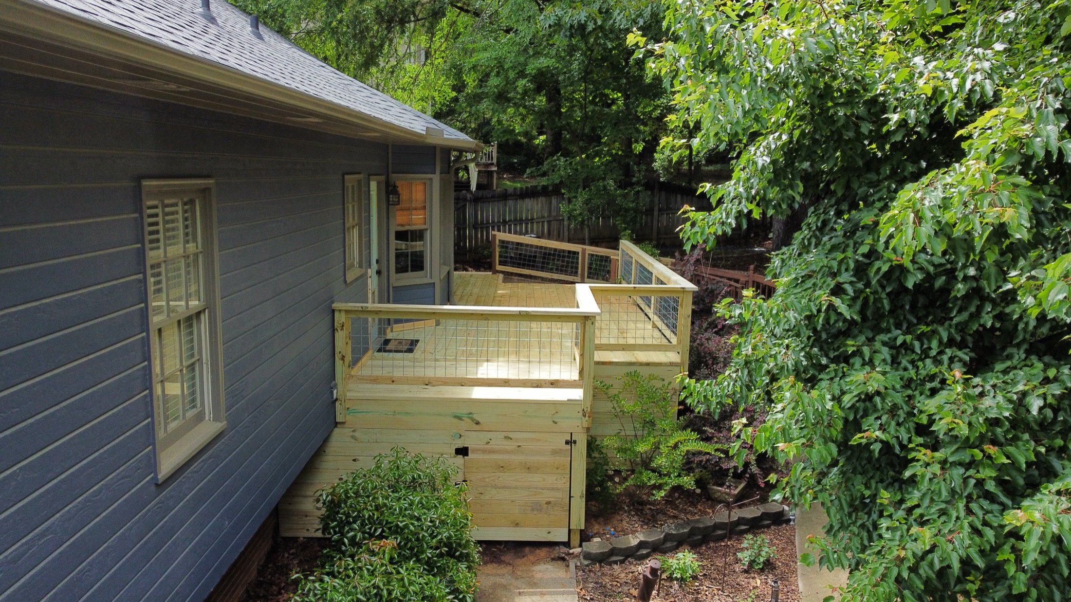 Ground-level deck on a brick home built by Redbone Woodworks