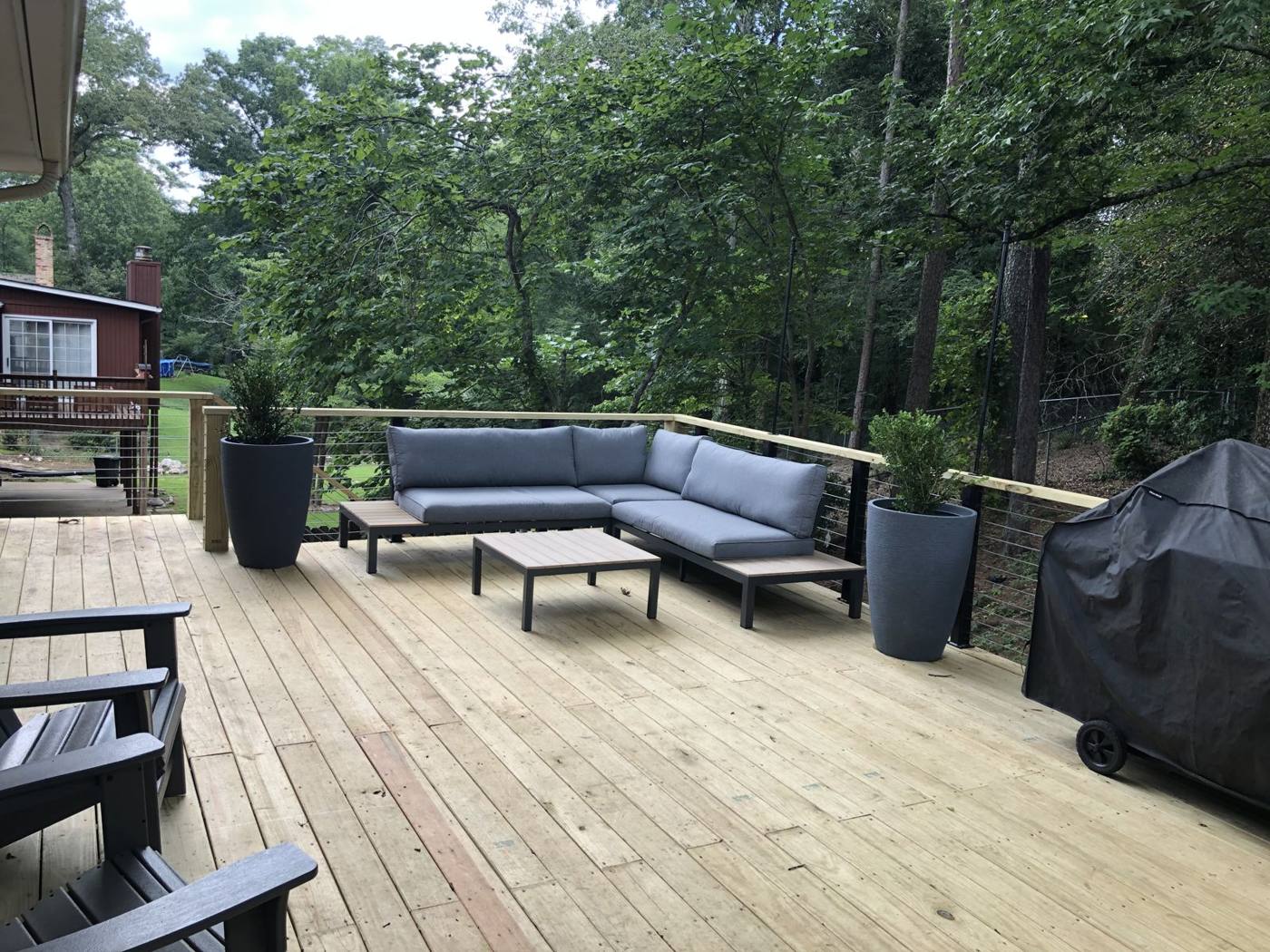 Finished deck with outdoor furniture built by Redbone Woodworks