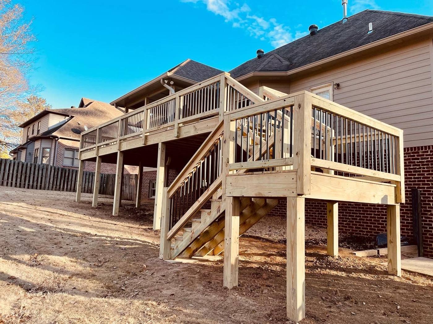 Deck with metal baluster railing and staircase built by Redbone Woodworks