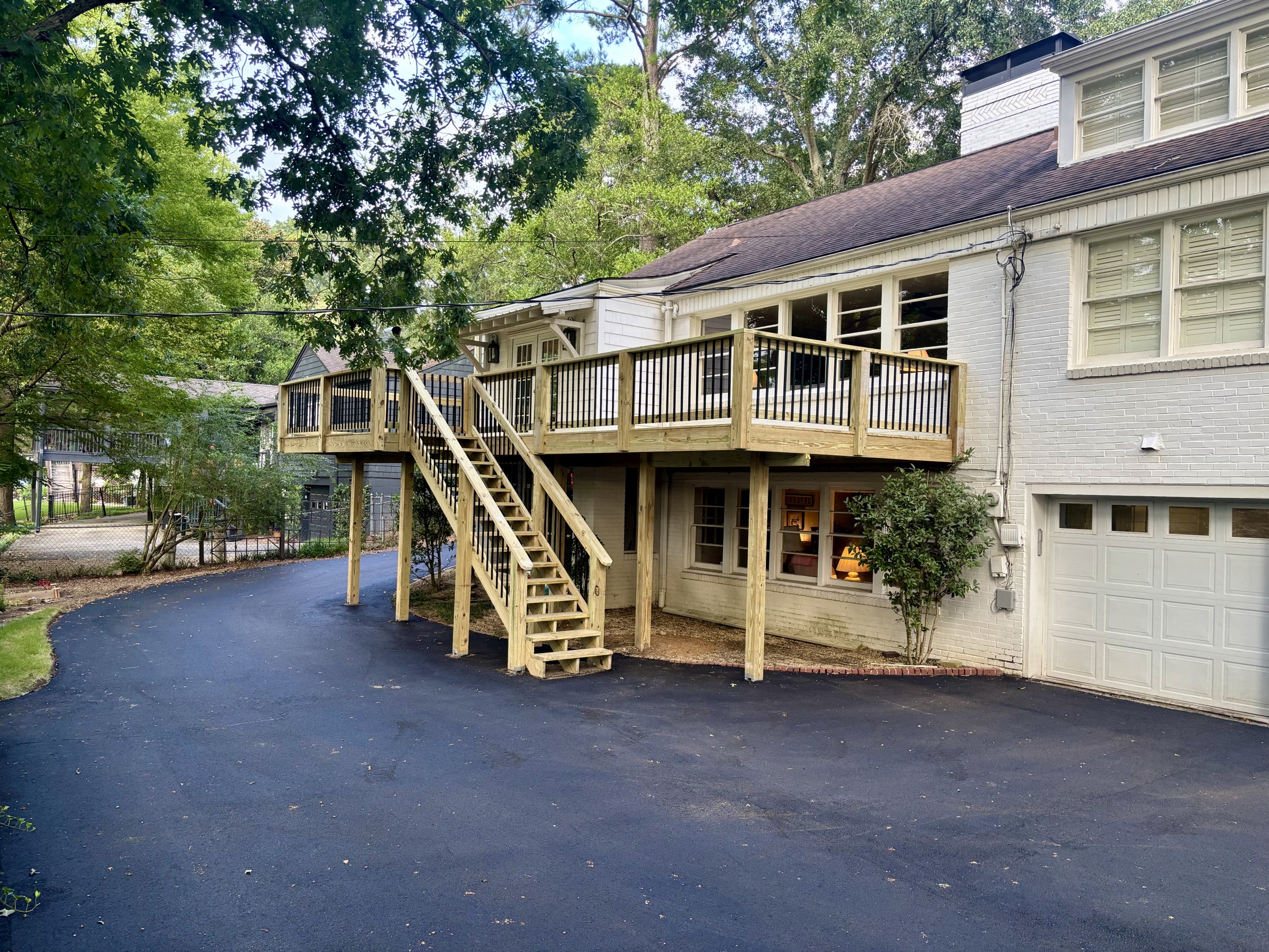 Elevated deck with long staircase built by Redbone Woodworks