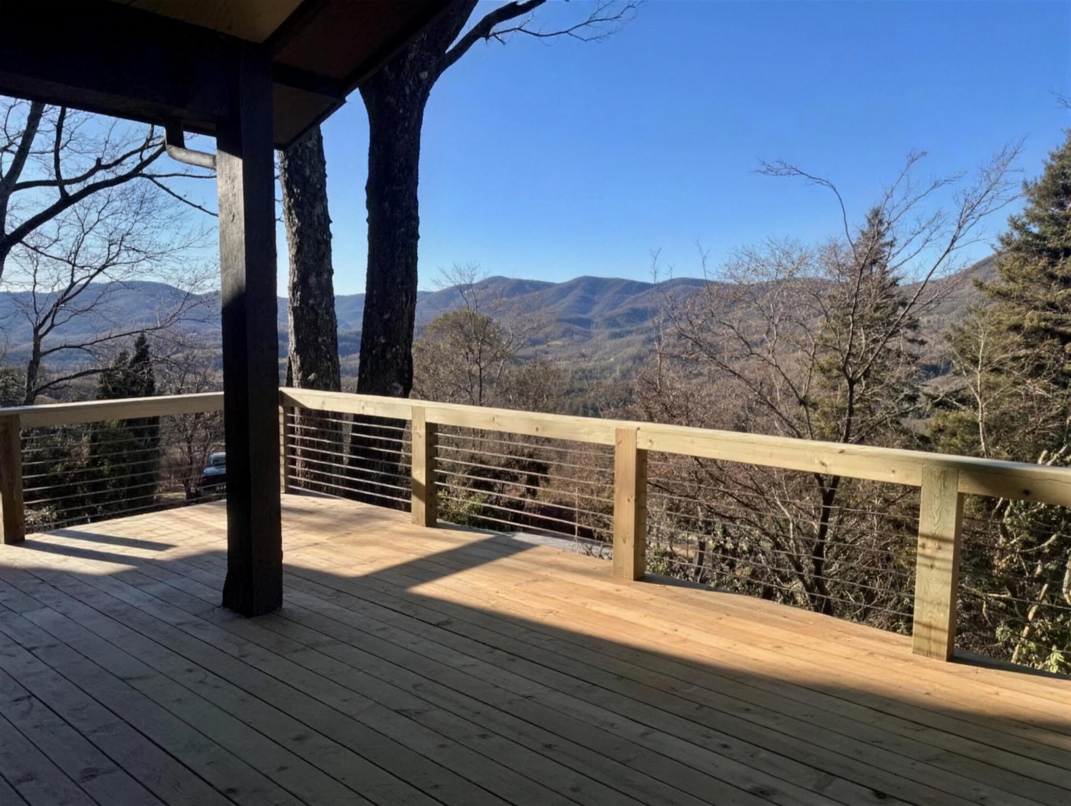 Screened porch with stone fireplace and sectional built by Redbone Woodworks
