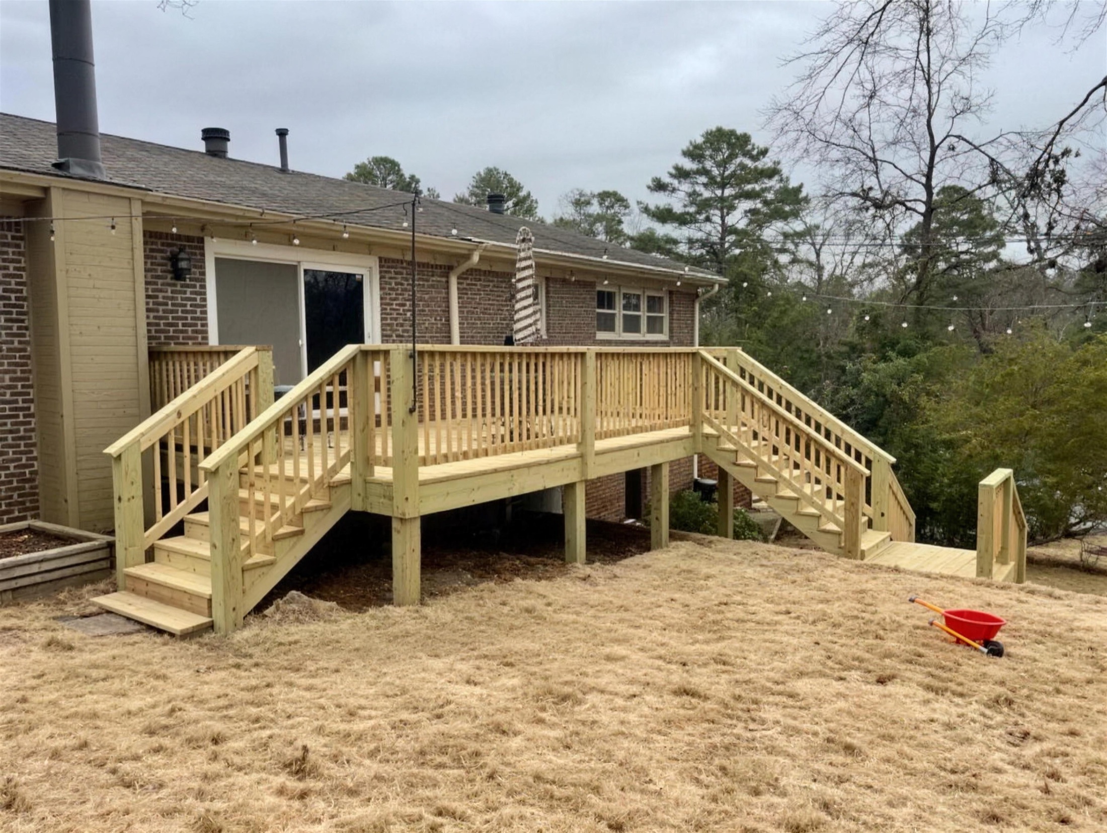 Screened porch with a hanging daybed swing built by Redbone Woodworks