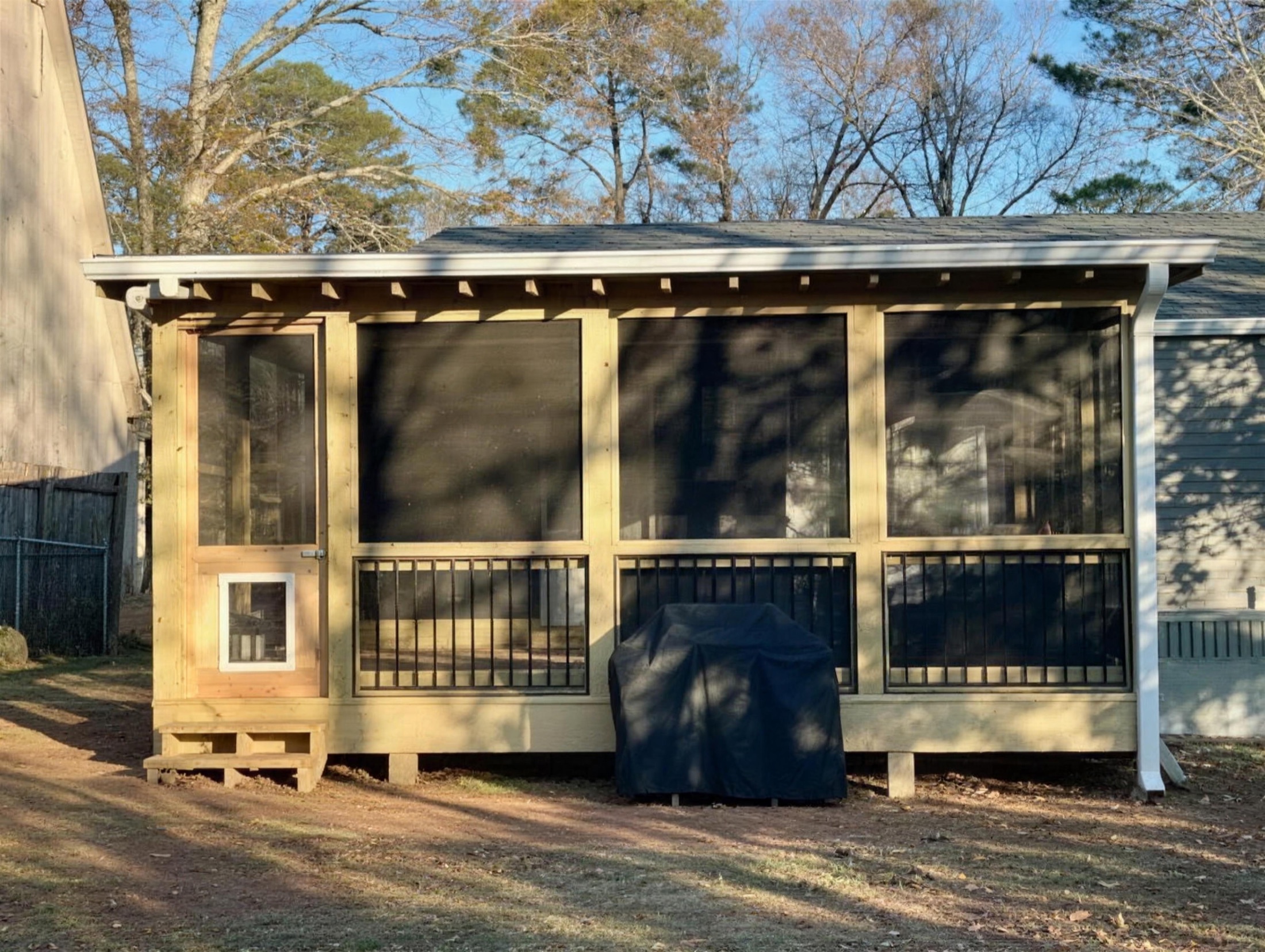 Screened porch addition with standing-seam metal roof built by Redbone Woodworks