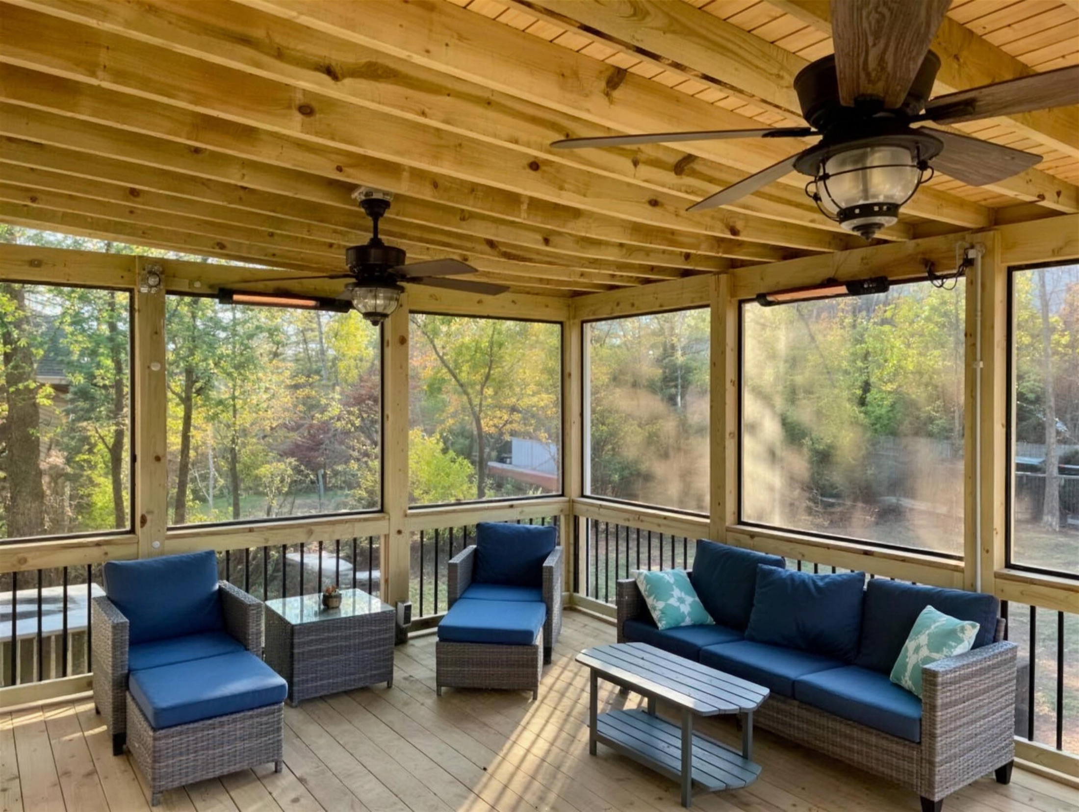 Screened porch furnished with wicker seating built by Redbone Woodworks